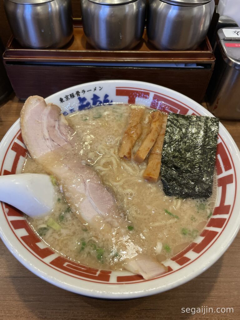 A bowl of Tokyo-style tonkotsu ramen with a thick slice of pork, bamboo shoots and a sheet of nori